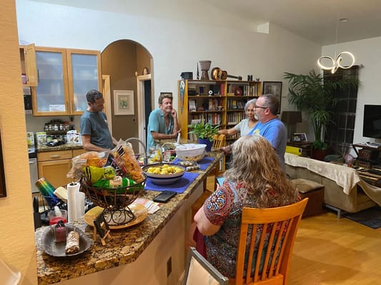 Residents socializing in a cozy kitchen area