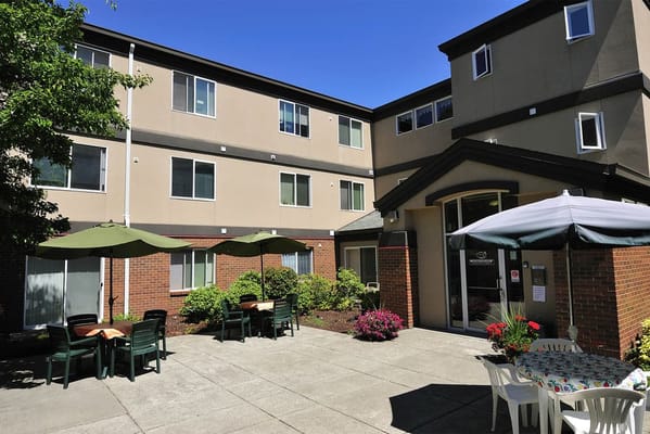 Outdoor courtyard with tables and umbrellas at Conservatory Place