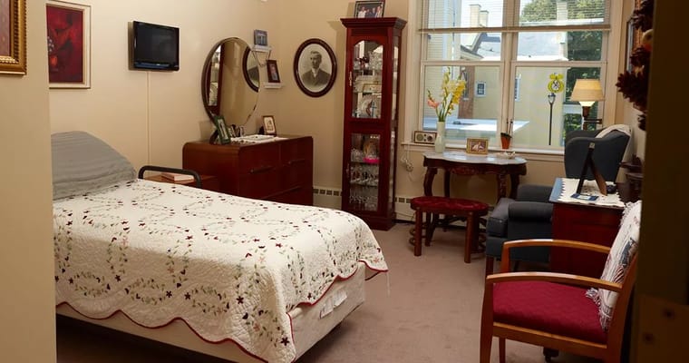 Cozy resident room with a bed and furniture