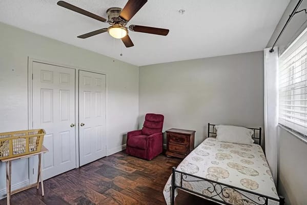 Bright private room with a bed and armchair