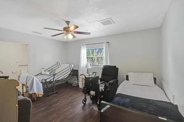 A private resident room with two beds and a window