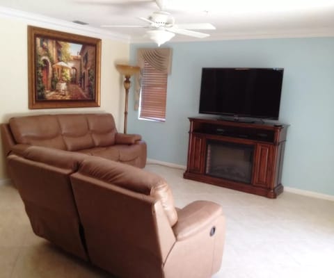 Comfortable living room with reclining chairs and a television