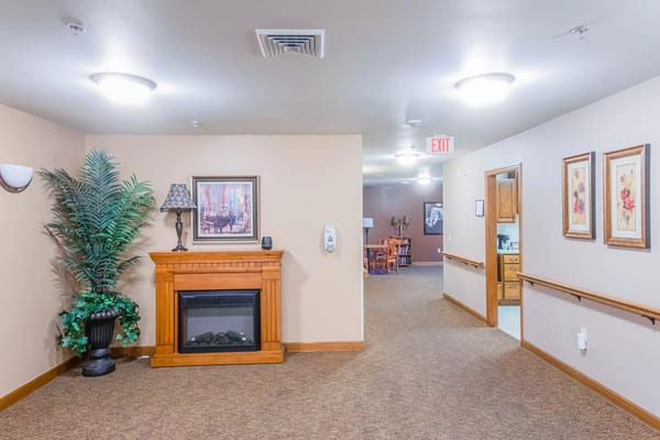 Cozy lobby with faux fireplace, art, and seating areas.