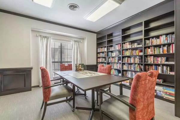 Interior of a shared activity room with bookshelves