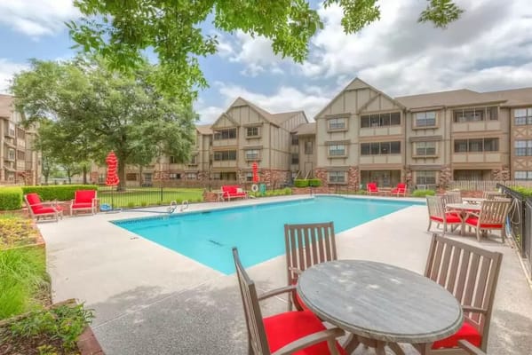 Outdoor pool area with seating and landscaping