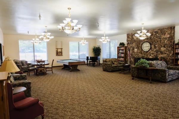 Common room with seating and a pool table in Country Club Manor.