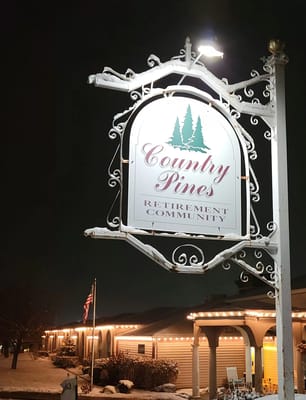 Signage for Country Pines Retirement Community at night