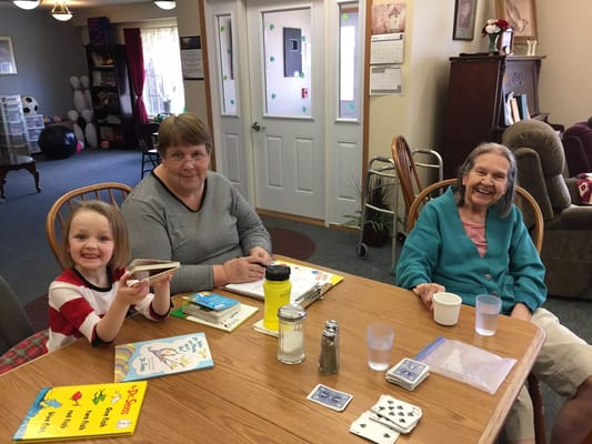 Residents and a child engaged in an activity at a table