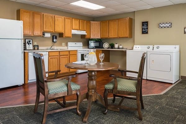 Bright kitchen area with dining table and appliances