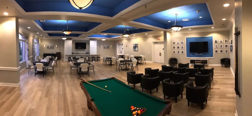 Interior view of a common area with seating and pool table