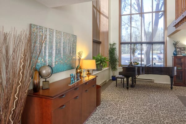 Bright common area with piano and decor