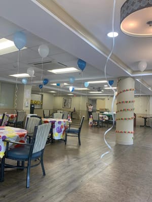 Activity room decorated for a celebration with balloons