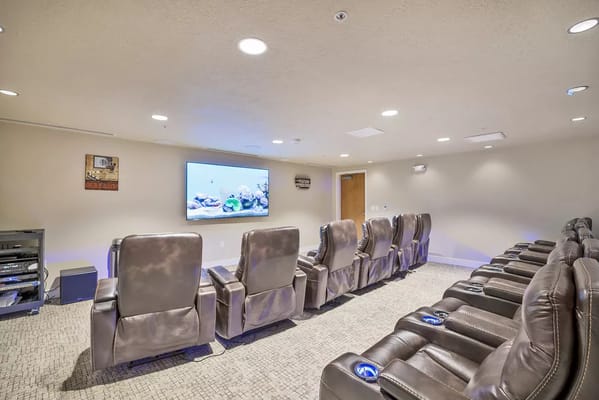 Comfortable seating in a theater room featuring a large screen