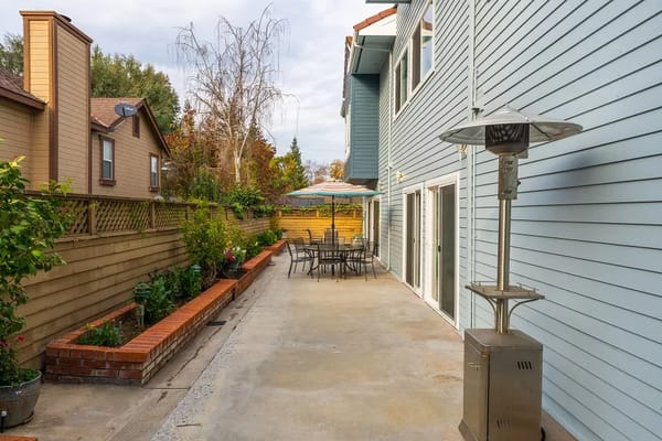 Outdoor patio area with seating and greenery