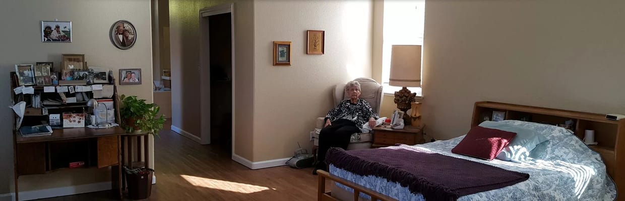 A resident sitting in a cozy private room