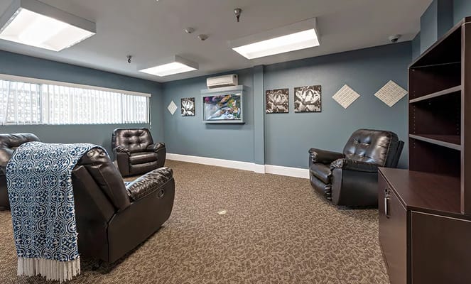 Comfortable lounge area with recliners and artwork