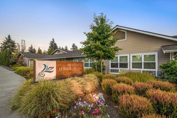 Main entrance sign of Crista Shores Senior Living facility surrounded by landscaping