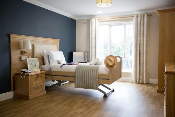 Bright and cozy bedroom with a hospital bed and soft furnishings