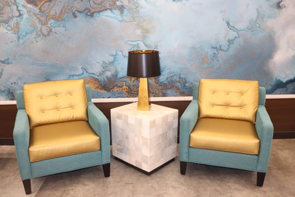 Bright interior seating area with yellow chairs and a lamp