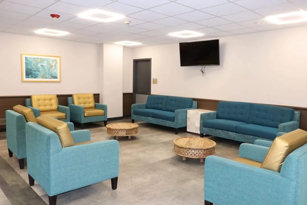 Interior common area with teal seating and tables