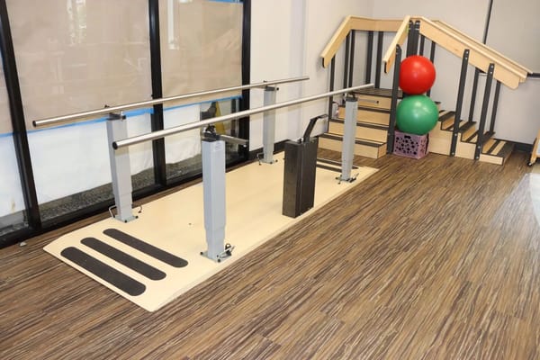 Rehabilitation therapy area with parallel bars and equipment