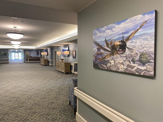 Interior hallway with artwork and seating areas