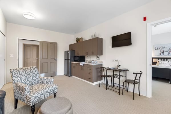 Well-furnished resident suite with kitchen and dining table