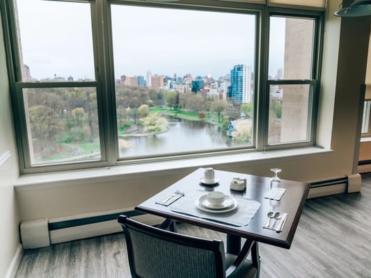 Dining setup with a city view through large windows