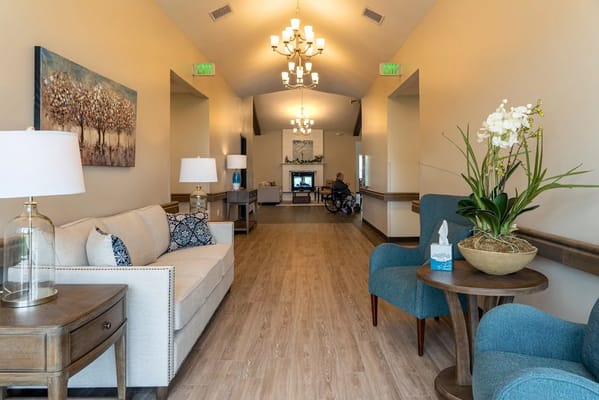 Bright lobby area with seating and a television