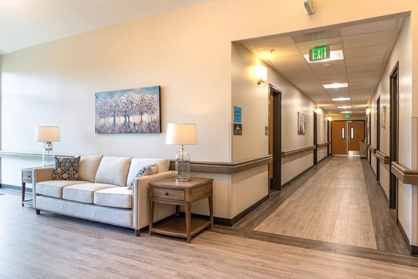 Bright hallway with couches and artwork