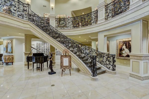 Elegant lobby featuring a grand staircase and piano