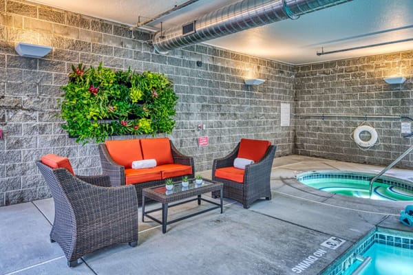 Comfortable seating area next to an indoor hot tub