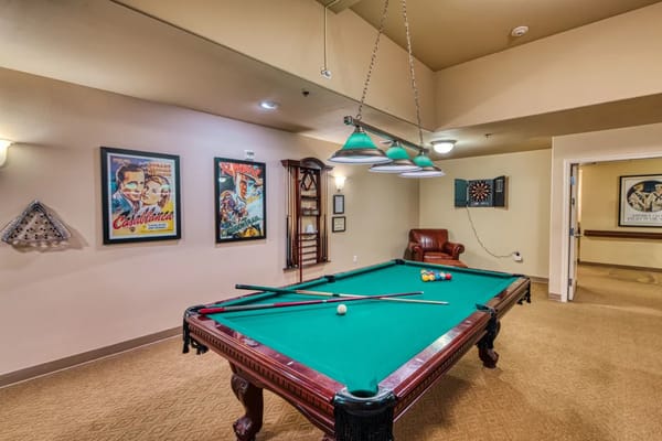 Billiards table in the game room with vintage movie posters.