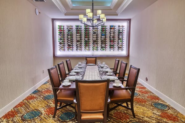 Dining room with a long table and wine wall
