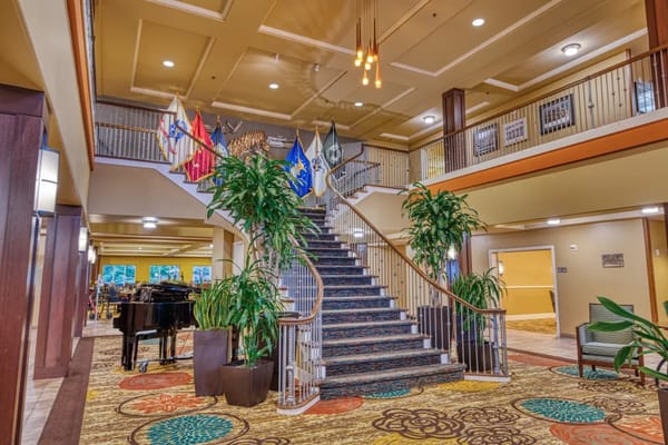 Interior view of the lobby featuring a staircase and piano.