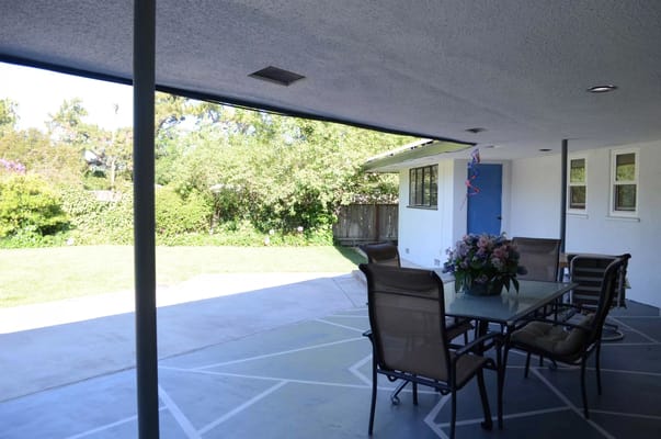 Outdoor patio with seating and a view of the garden