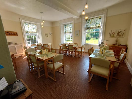 Bright dining room with tables set for meals