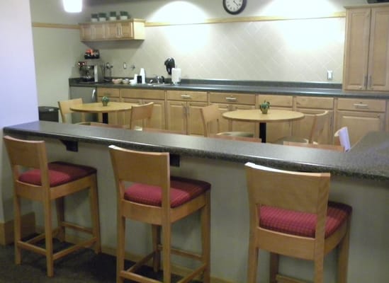 Kitchen area with bar stools and tables