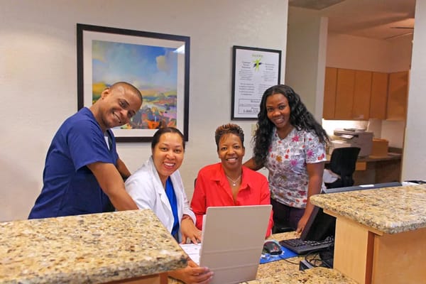 Staff members collaborating at the reception desk