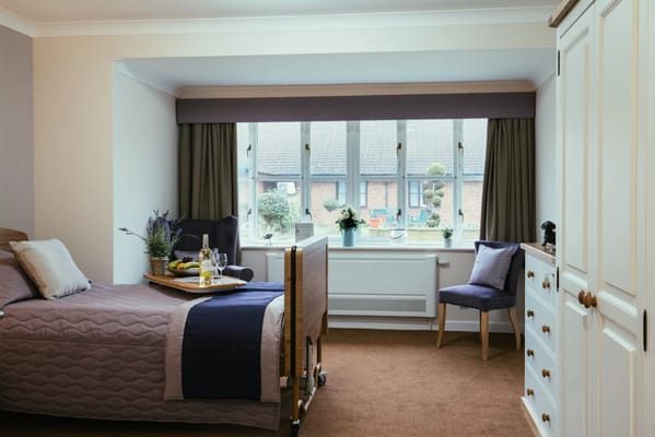 A cozy interior room with a bed and breakfast tray