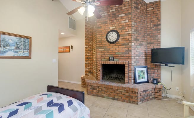 Cozy interior of a resident room with brick fireplace