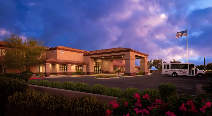 Exterior view of Desert Winds Assisted Living facility at twilight