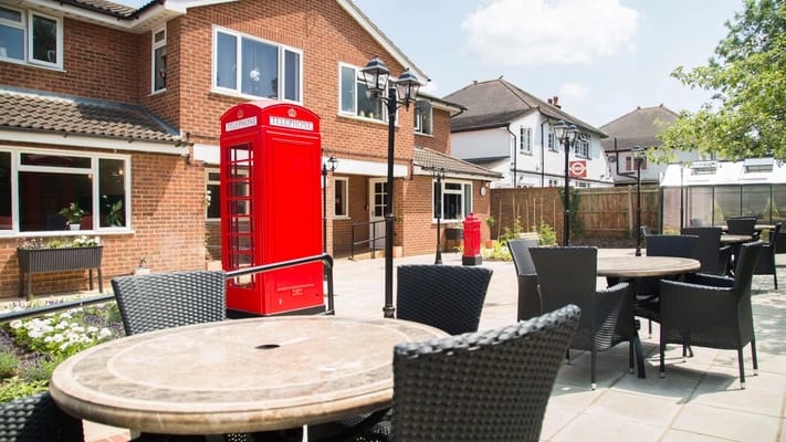 Outdoor seating area with a classic red phone box