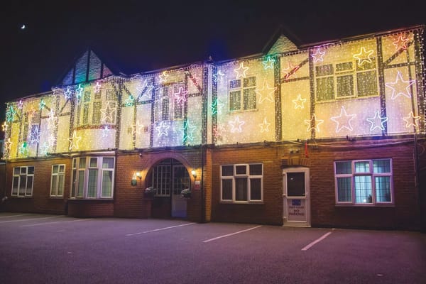 Exterior of the facility decorated with colorful lights