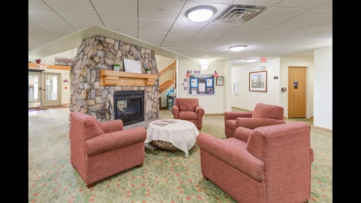 Interior common area with seating around a fireplace