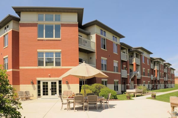 Exterior view of the assisted living facility with outdoor seating