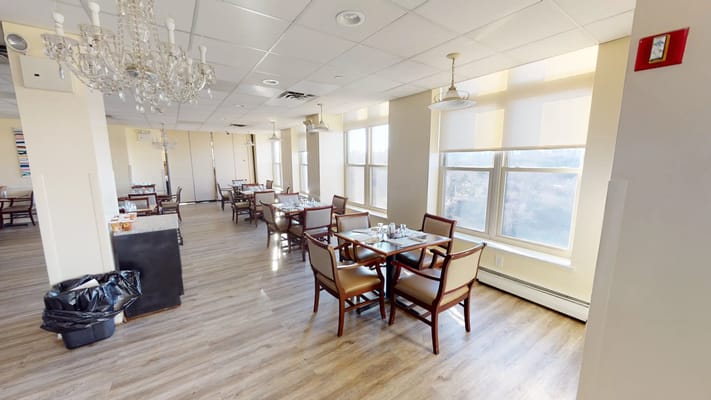 Bright dining room with natural light and tables set for meals