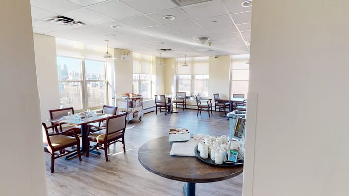 Bright dining room with tables and food service area