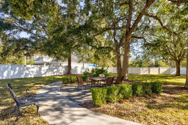 A peaceful outdoor seating area surrounded by trees