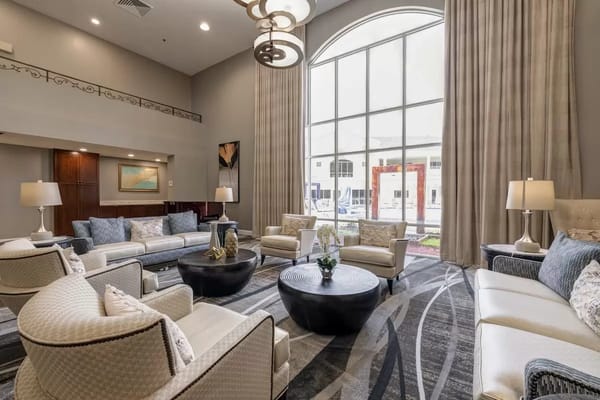 A stylish common area with seating and large windows